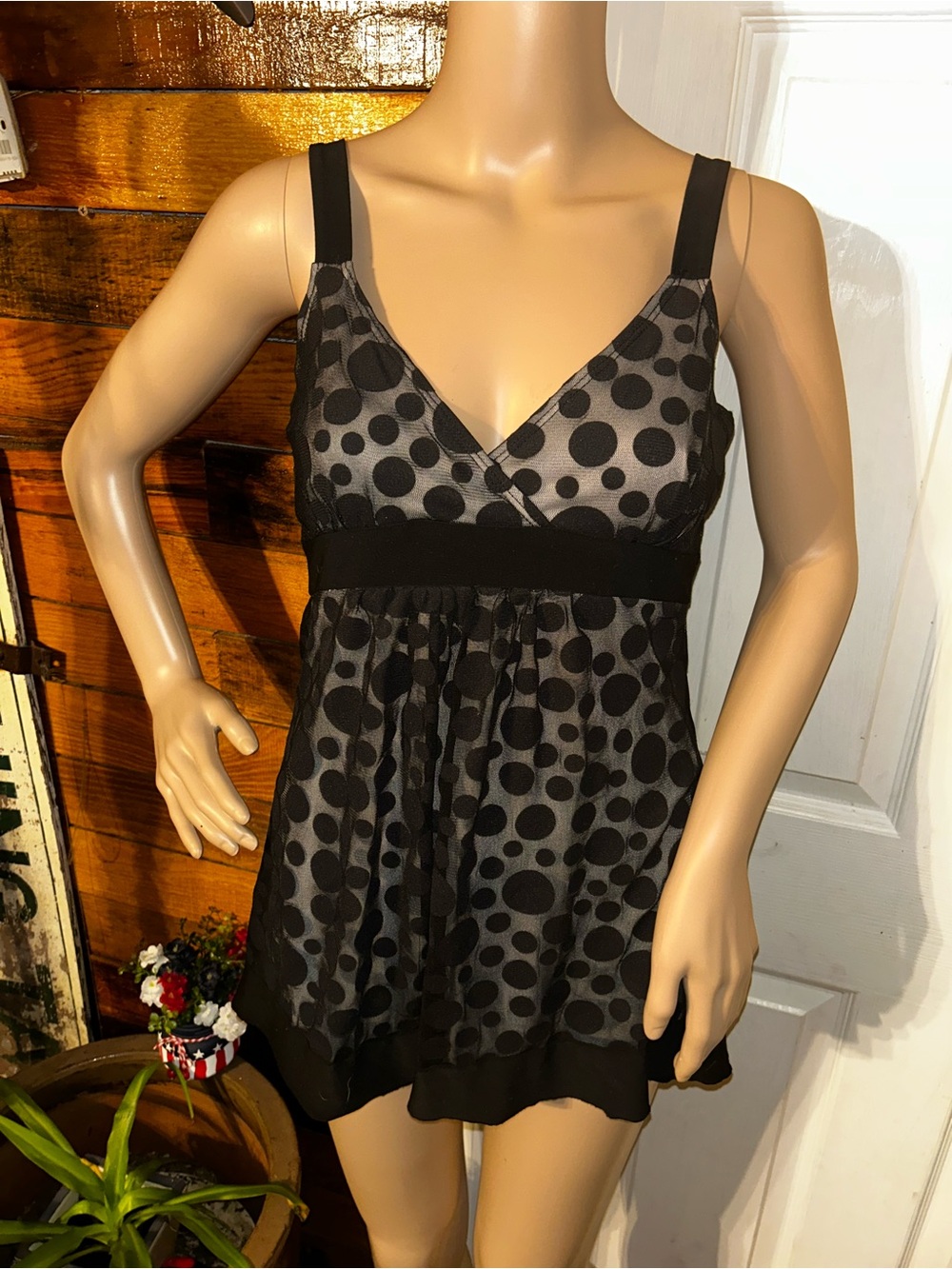 black-and-white polka-dot babydoll blouse features a playful sheer mesh overlay